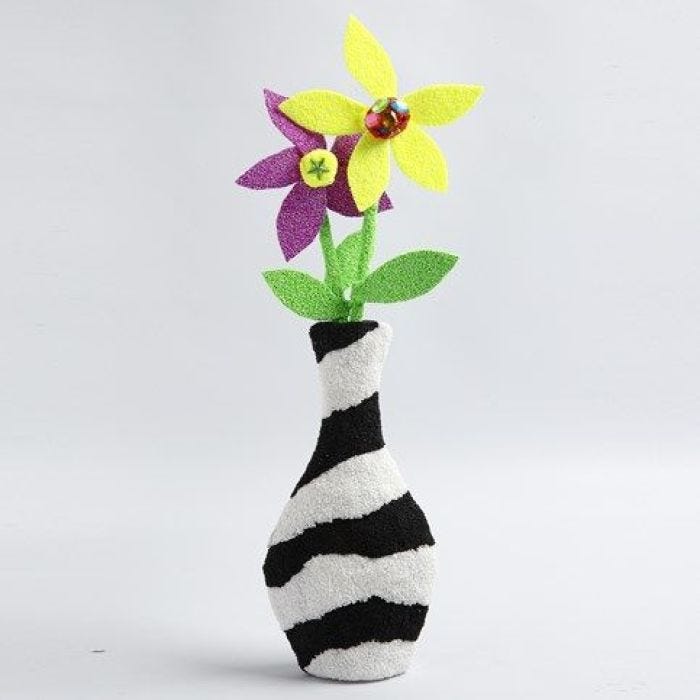 Eine verzierte Pappmaché-Vase mit Blumen aus Foam Clay