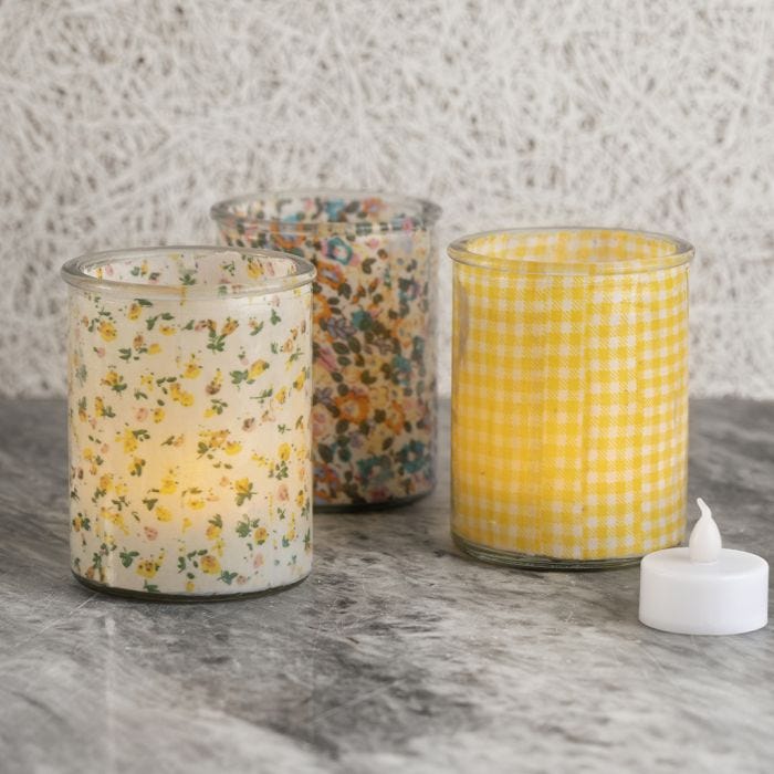 Candle holders decorated with fabric on the inside