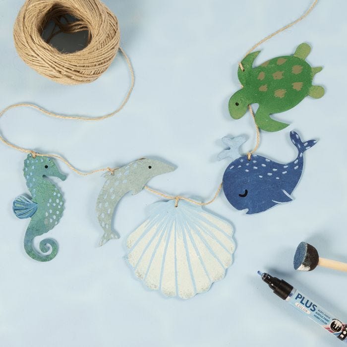 A garland with wooden sea creatures decorated with craft paint