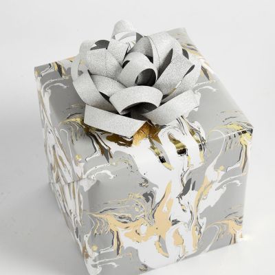 Geschenkverpackung mit einer Rosette aus Papierstreifen