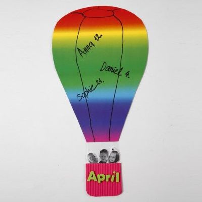 Ein Heißluftballon aus Regenbogen-Karton und Korb aus Wellpappe