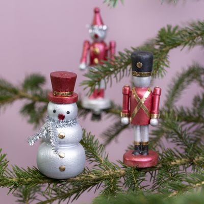 Weihnachtliche Holzfiguren auf Metallklammern
